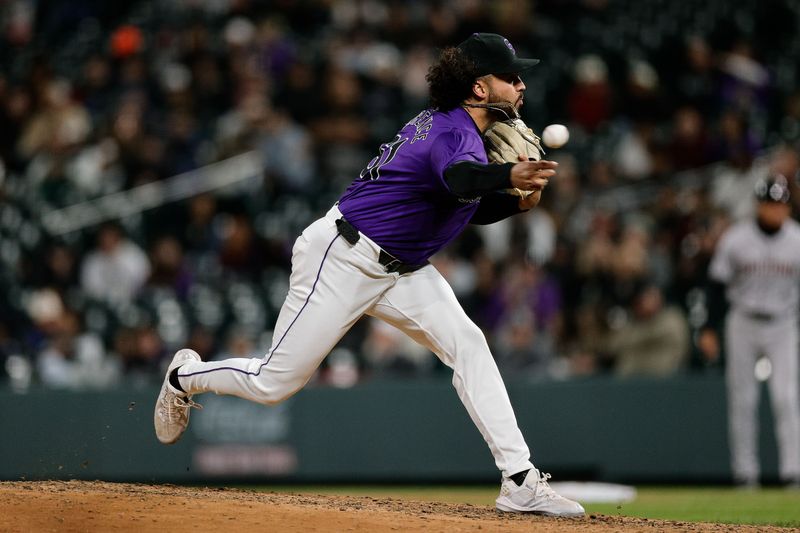 Apr 8, 2024; Denver, Colorado, USA; Colorado Rockies relief pitcher Justin Lawrence (61) pitches in the eighth inning against the Arizona Diamondbacks at Coors Field. Mandatory Credit: Isaiah J. Downing-USA TODAY Sports