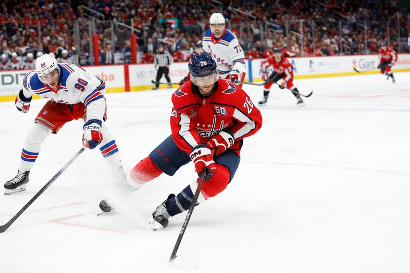 Oct 29, 2024; Washington, District of Columbia, USA; Washington Capitals center Nic Dowd (26) skates with the puck as New York Rangers defenseman Victor Mancini (90) defends in the third period at Capital One Arena. Mandatory Credit: Geoff Burke-Imagn Images