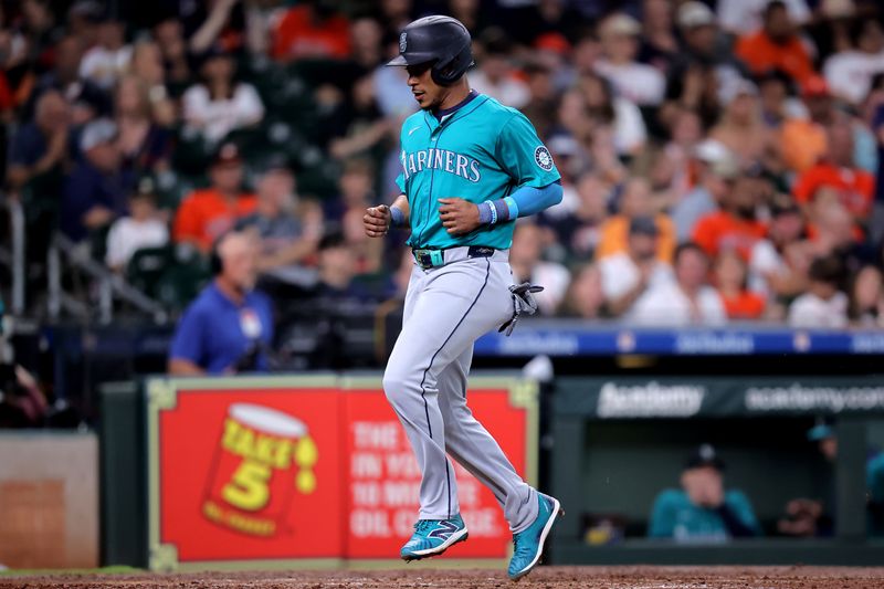 May 4, 2024; Houston, Texas, USA; Seattle Mariners second baseman Jorge Polanco (7) crosses home plate to score a run against the Houston Astros during the fourth inning at Minute Maid Park. Mandatory Credit: Erik Williams-USA TODAY Sports