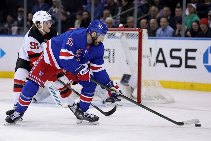 Mar 11, 2024; New York, New York, USA; New York Rangers center Barclay Goodrow (21) controls the puck against New Jersey Devils center Dawson Mercer (91) during the third period at Madison Square Garden. Mandatory Credit: Brad Penner-USA TODAY Sports