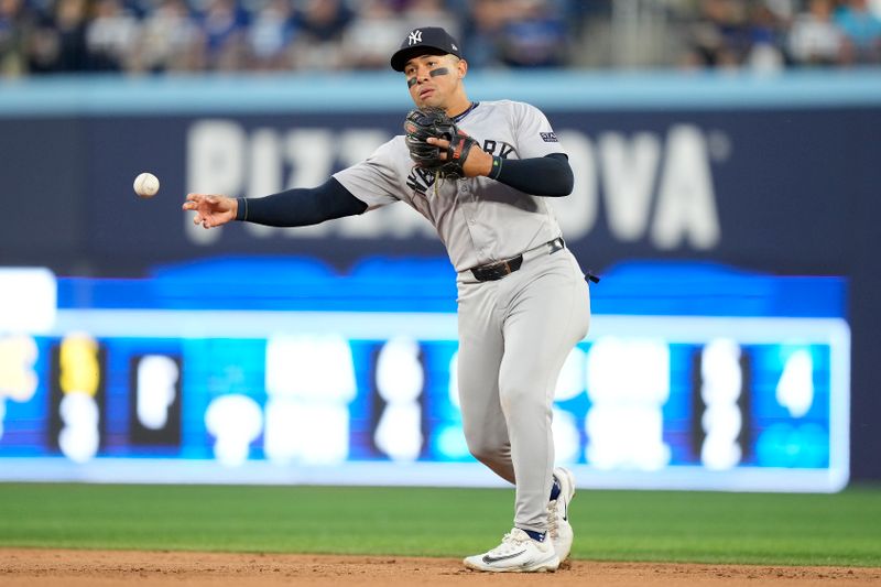 Jun 27, 2024; Toronto, Ontario, CAN; New York Yankees second baseman Jahmai Jones (14) throws out Toronto Blue Jays shortstop Bo Bichette (not pictured) during the sixth inning at Rogers Centre. Mandatory Credit: John E. Sokolowski-USA TODAY Sports