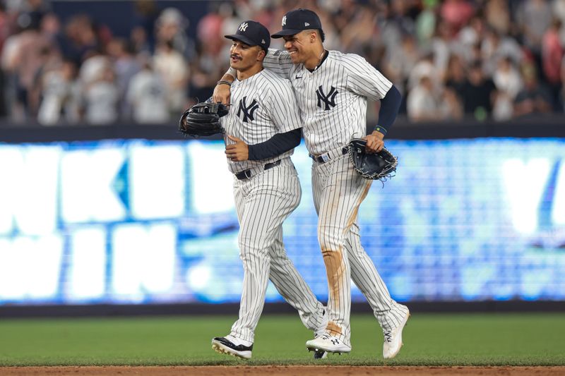 Jun 18, 2024; Bronx, New York, USA; New York Yankees right fielder Juan Soto (22) and centerfielder Trent Grisham (12) celebrates after defeating the Baltimore Orioles at Yankee Stadium. Mandatory Credit: Vincent Carchietta-USA TODAY Sports