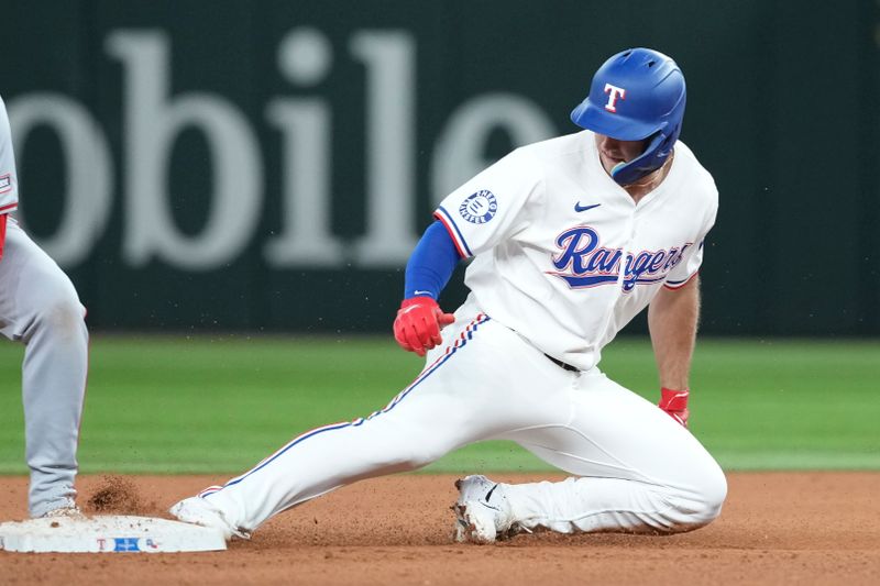 Sep 7, 2024; Arlington, Texas, USA; Texas Rangers center fielder Wyatt Langford (36) slides to second base on a RBI double against the Los Angeles Angels during the eighth inning at Globe Life Field. Mandatory Credit: Jim Cowsert-Imagn Images