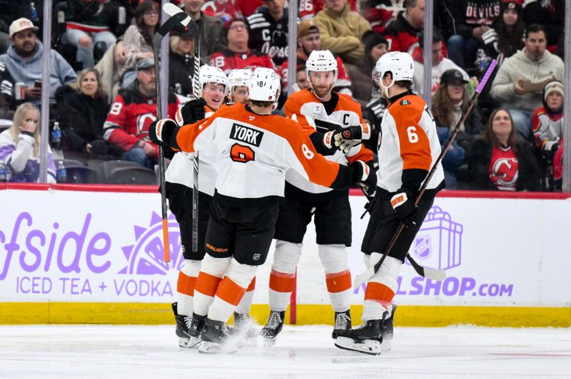 Nov 29, 2025; Newark, New Jersey, USA; Philadelphia Flyers right wing Matvei Michkov (39) celebrates with teammates after scoring a goal against the New Jersey Devils during the second period at Prudential Center. Mandatory Credit: John Jones-Imagn Images