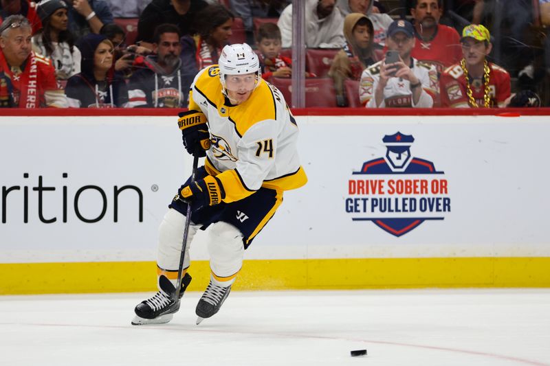 Nov 7, 2024; Sunrise, Florida, USA; Nashville Predators center Gustav Nyquist (14) moves the puck against the Florida Panthers during the second period at Amerant Bank Arena. Mandatory Credit: Sam Navarro-Imagn Images