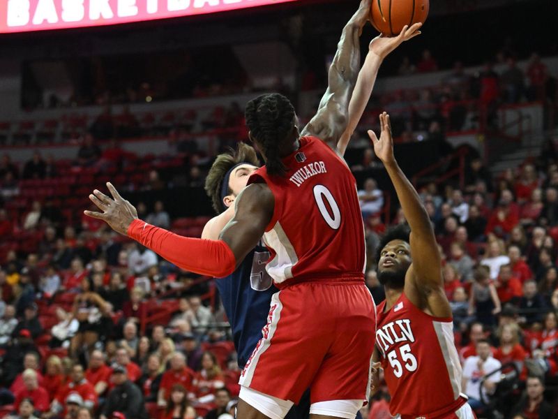 Jan 28, 2023; Las Vegas, Nevada, USA; Nevada Wolf Pack center Will Baker (50) is blocked by UNLV Runnin' Rebels forward Victor Iwuakor (0) in the first half at Thomas & Mack Center. Mandatory Credit: Candice Ward-USA TODAY Sports