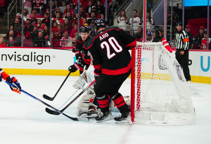 Apr 22, 2024; Raleigh, North Carolina, USA; Carolina Hurricanes center Sebastian Aho (20) scores a goal against the New York Islanders during the third period in game two of the first round of the 2024 Stanley Cup Playoffs at PNC Arena. Mandatory Credit: James Guillory-USA TODAY Sports