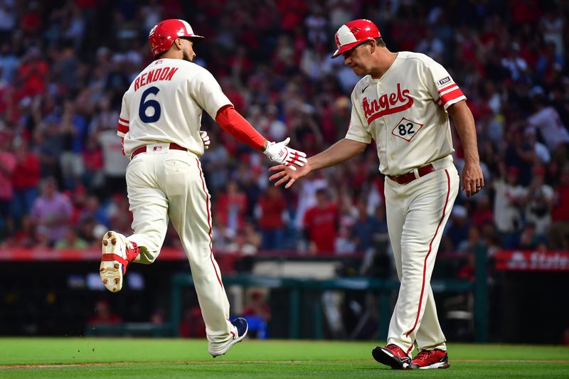 Jul 1, 2023; Anaheim, California, USA; Los Angeles Angels third baseman Anthony Rendon (6) is greeted by third base coach Bill Haselman (82) after hitting a solo home run against the Arizona Diamondbacks during the fourth inning at Angel Stadium. Mandatory Credit: Gary A. Vasquez-USA TODAY Sports