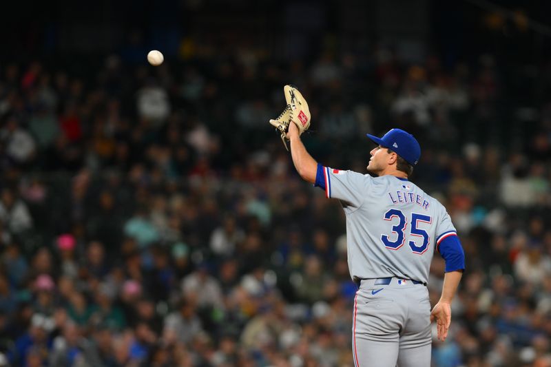 Sep 14, 2024; Seattle, Washington, USA; Texas Rangers relief pitcher Jack Leiter (35) catches a thrown ball during the eighth inning against the Seattle Mariners at T-Mobile Park. Mandatory Credit: Steven Bisig-Imagn Images