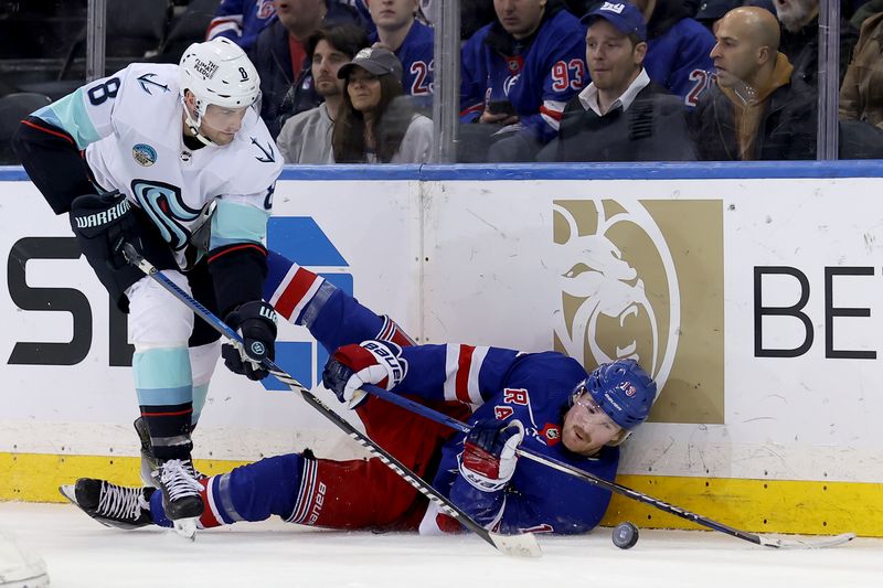 Jan 16, 2024; New York, New York, USA; Seattle Kraken defenseman Brian Dumoulin (8) and New York Rangers left wing Alexis Lafreniere (13) fight for the puck during the third period at Madison Square Garden. Mandatory Credit: Brad Penner-USA TODAY Sports