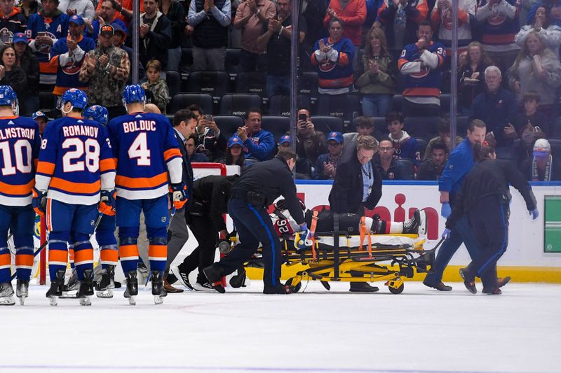 Oct 26, 2023; Elmont, New York, USA; Players from the Ottawa Senators and the New York Islanders watch Ottawa Senators defenseman Erik Brannstrom (26) getsput on a stretcher after a hit from New York Islanders right wing Cal Clutterbuck (15) during the second period at UBS Arena. Mandatory Credit: Dennis Schneidler-USA TODAY Sports