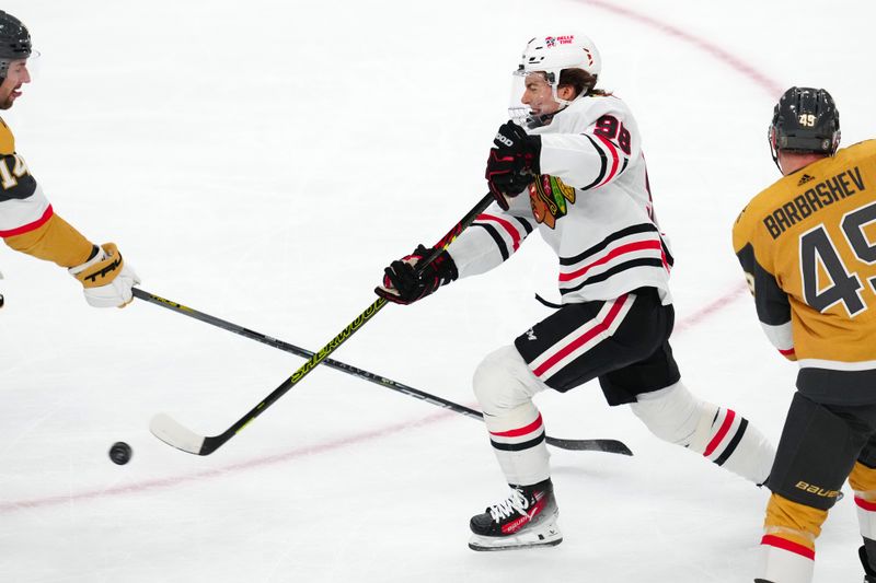 Apr 16, 2024; Las Vegas, Nevada, USA; Chicago Blackhawks center Connor Bedard (98) shoots against the Vegas Golden Knights during the first period at T-Mobile Arena. Mandatory Credit: Stephen R. Sylvanie-USA TODAY Sports