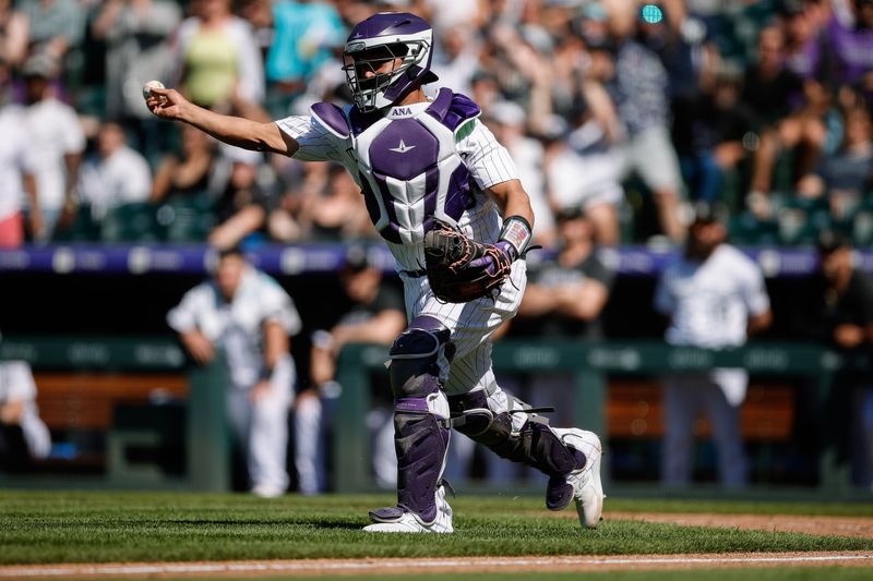 Jul 16, 2023; Denver, Colorado, USA; Colorado Rockies catcher Elias Diaz (35) makes a throw to third in the ninth inning against the New York Yankees at Coors Field. Mandatory Credit: Isaiah J. Downing-USA TODAY Sports