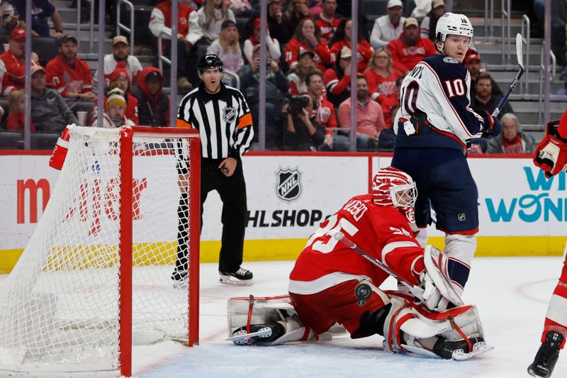 Nov 11, 2023; Detroit, Michigan, USA;  Detroit Red Wings goaltender Ville Husso (35) makes a save in front of Columbus Blue Jackets left wing Dmitri Voronkov (10) in the third period at Little Caesars Arena. Mandatory Credit: Rick Osentoski-USA TODAY Sports