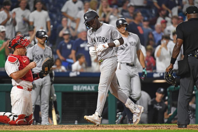 Jul 29, 2024; Philadelphia, Pennsylvania, USA;  New York Yankees third baseman Jazz Chisholm, Jr (13) steps on home after hitting his second home run of the game against the Philadelphia Phillies during the ninth inning at Citizens Bank Park. Mandatory Credit: Eric Hartline-USA TODAY Sports