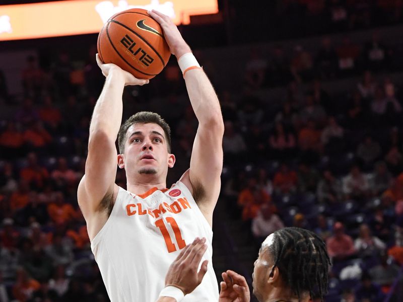 Feb 27, 2024; Clemson, South Carolina, USA;  Clemson graduate Joseph Girard III  takes a sot near Pitt guard Ishmael Leggett (5) during the first half at Littlejohn Coliseum. Mandatory Credit: Ken Ruinard-USA TODAY Sports