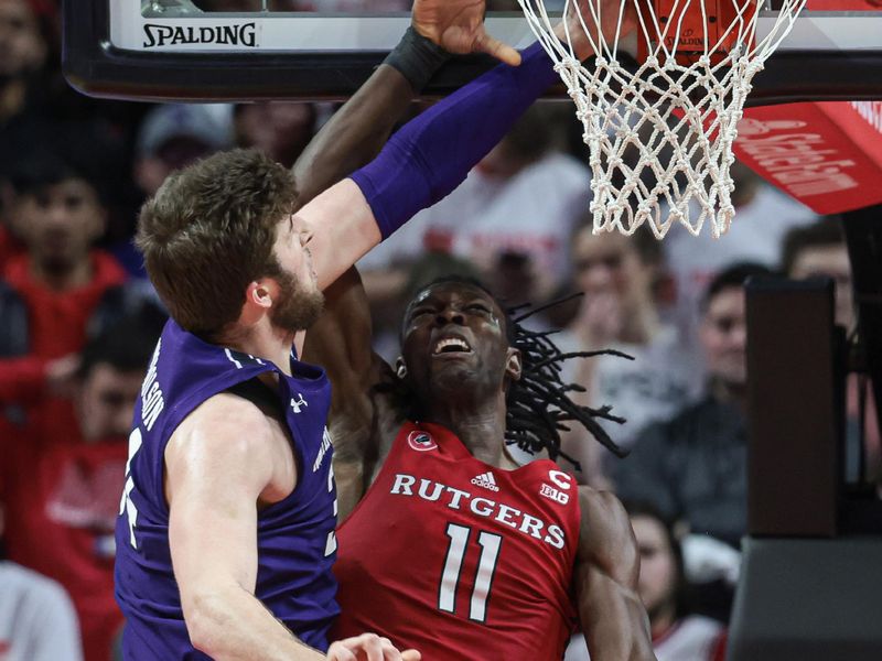 Mar 5, 2023; Piscataway, New Jersey, USA; Northwestern Wildcats forward Gus Hurlburt (54) blocks a shot by Rutgers Scarlet Knights center Clifford Omoruyi (11) during the first half at Jersey Mike's Arena. Mandatory Credit: Vincent Carchietta-USA TODAY Sports