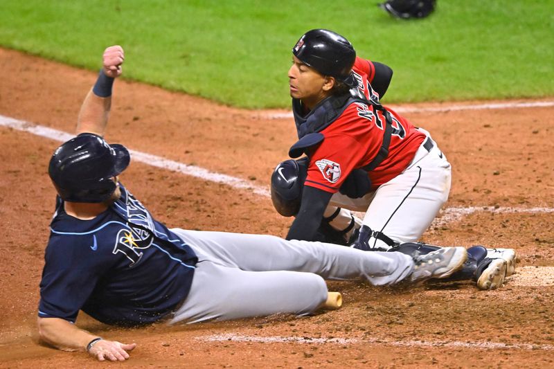 Sep 2, 2023; Cleveland, Ohio, USA; Tampa Bay Rays right fielder Luke Raley (55) is tagged out by Cleveland Guardians catcher Bo Naylor (23) in the tenth inning at Progressive Field. Mandatory Credit: David Richard-USA TODAY Sports