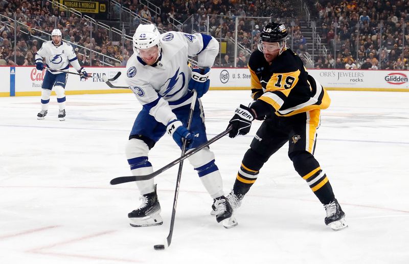 Apr 6, 2024; Pittsburgh, Pennsylvania, USA;  Tampa Bay Lightning defenseman Darren Raddysh (43) handles the puck against Pittsburgh Penguins right wing Reilly Smith (19) during the first period at PPG Paints Arena. Mandatory Credit: Charles LeClaire-USA TODAY Sports