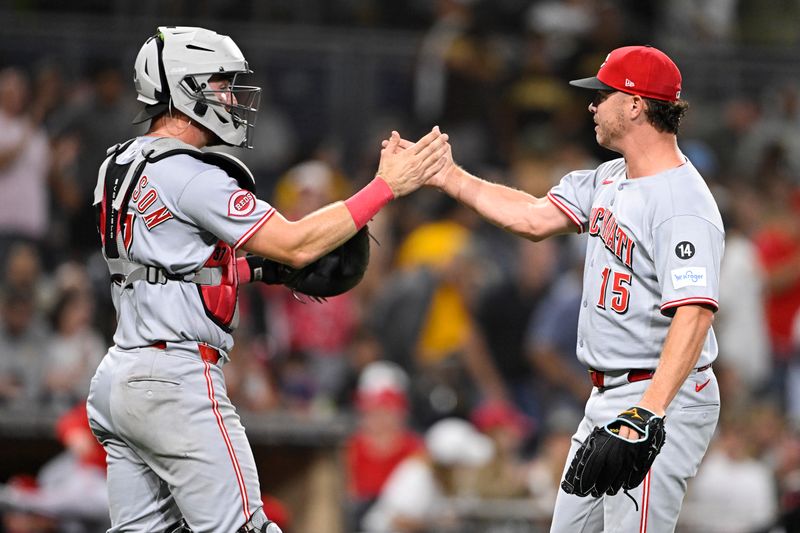 Sep 9, 2025; San Diego, California, USA; Cincinnati Reds relief pitcher Emilio Pagan (15) and Tyler Stephenson (37) celebrate after the Reds beat the San Diego Padres at Petco Park. Mandatory Credit: Denis Poroy-Imagn Images