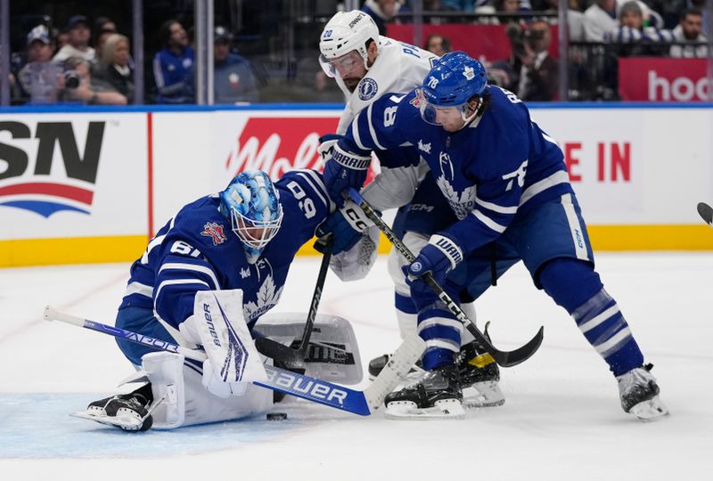 Nov 6, 2023; Toronto, Ontario, CAN; Toronto Maple Leafs goaltender Joseph Woll (60) makes a save on Tampa Bay Lightning forward Nicholas Paul (20) as Toronto Maple Leafs defenseman TJ Brodie (78) helps out during the second period at Scotiabank Arena. Mandatory Credit: John E. Sokolowski-USA TODAY Sports