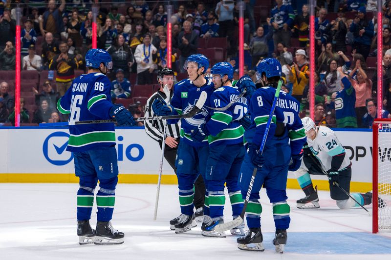 Sep 24, 2024; Vancouver, British Columbia, CAN;  Vancouver Canucks defenseman Christian Wolanin (86) and forward Aatu Raty (54) and forward Nils Hoglander (21) and forward Conor Garland (8) celebrate Hoglander’s goal against the Seattle Kraken during the first period at Rogers Arena. Mandatory Credit: Bob Frid-Imagn Images