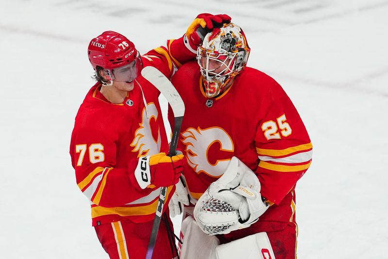 Jan 13, 2024; Las Vegas, Nevada, USA; Calgary Flames goaltender Jacob Markstrom (25) celebrates with Calgary Flames center Martin Pospisil (76) after the Flames defeated the Vegas Golden Knights 3-1 at T-Mobile Arena. Mandatory Credit: Stephen R. Sylvanie-USA TODAY Sports