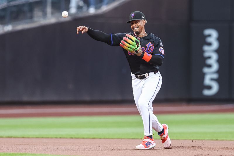 Jul 12, 2024; New York City, New York, USA;  New York Mets shortstop Francisco Lindor (12) throws a runner out at first base in the first inning against the Colorado Rockies at Citi Field. Mandatory Credit: Wendell Cruz-USA TODAY Sports