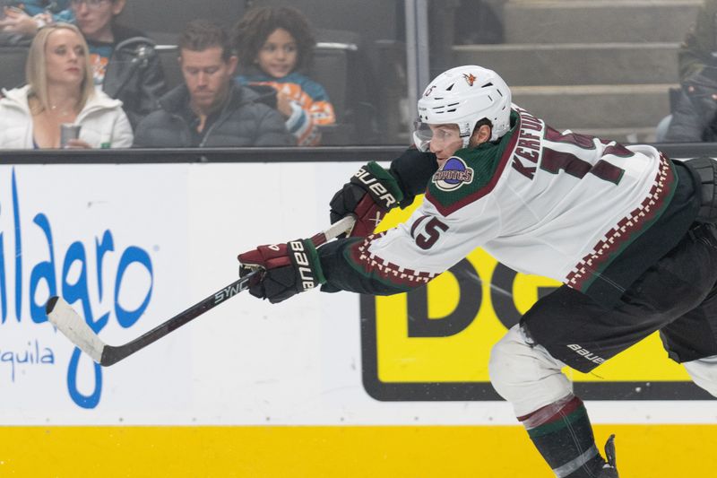 Dec 21, 2023; San Jose, California, USA; Arizona Coyotes center Alexander Kerfoot (15) passes the puck during the second period against the San Jose Sharks at SAP Center at San Jose. Mandatory Credit: Stan Szeto-USA TODAY Sports