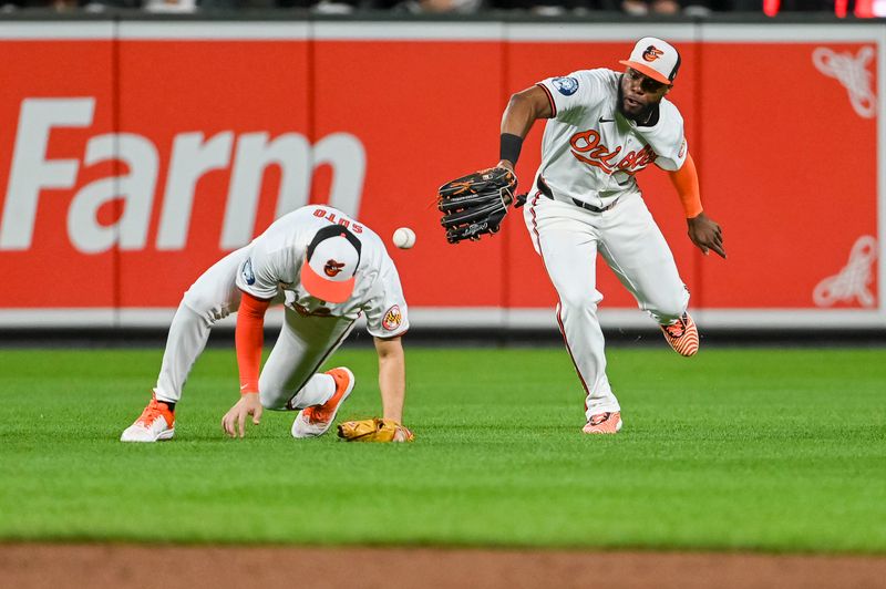 Sep 17, 2024; Baltimore, Maryland, USA; Baltimore Orioles outfielder Cedric Mullins (31) can’t secure San Francisco Giants outfielder Heliot Ramos (17)  second inning fly ball at Oriole Park at Camden Yards. Mandatory Credit: Tommy Gilligan-Imagn Images