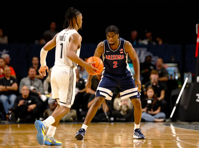 Jan 17, 2026; Orlando, Florida, USA;  Arizona Wildcats forward Dwayne Aristode (2) defends Central Florida Knights guard Themus Fulks (1) in the second half at Addition Financial Arena. Mandatory Credit: Russell Lansford-Imagn Images