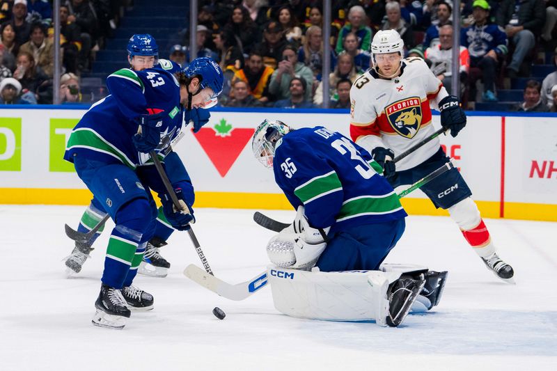 Dec 14, 2023; Vancouver, British Columbia, CAN; Florida Panthers forward Sam Reinhart (13) watches as Vancouver Canucks defenseman Quinn Hughes (43) and goalie Thatcher Demko (35) look at the rebound in the first period at Rogers Arena. Vancouver won 4-0. Mandatory Credit: Bob Frid-USA TODAY Sports