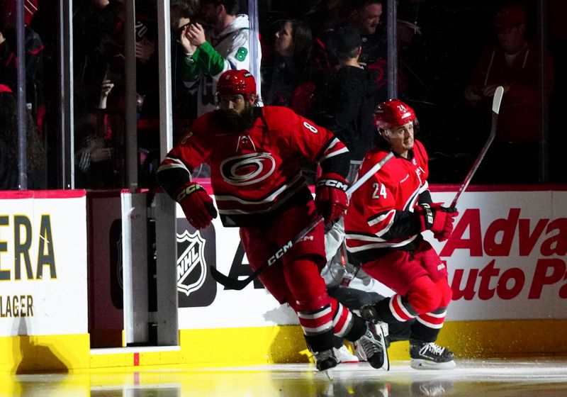 Mar 2, 2024; Raleigh, North Carolina, USA; Carolina Hurricanes defenseman Brent Burns (8) and center Seth Jarvis (24) skate out onto the ice before the game against the Winnipeg Jets at PNC Arena. Mandatory Credit: James Guillory-USA TODAY Sports