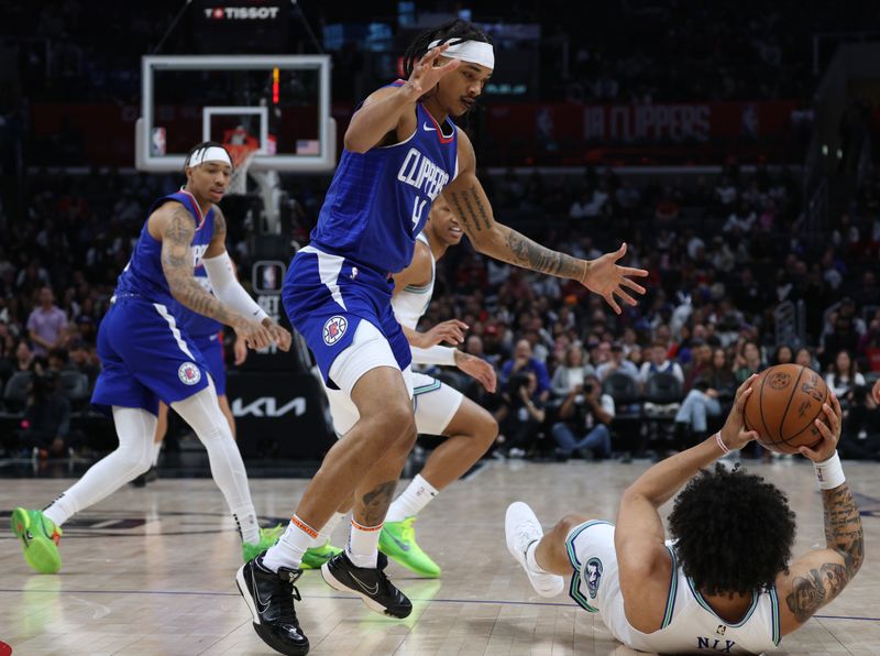 LOS ANGELES, CALIFORNIA - MARCH 12: Brandon Boston Jr. #4 of the LA Clippers defends a pass from Daishen Nix #12 of the Minnesota Timberwolves during a 118-100 Timberwolves win at Crypto.com Arena on March 12, 2024 in Los Angeles, California. (Photo by Harry How/Getty Images)