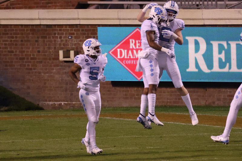 Oct 31, 2020; Charlottesville, Virginia, USA; North Carolina Tar Heels wide receiver Khafre Brown (1) celebrates with Tar Heels wide receiver Stephen Gosnell (12) after scoring a touchdown against the Virginia Cavaliers in the second quarter at Scott Stadium. Mandatory Credit: Geoff Burke-USA TODAY Sports