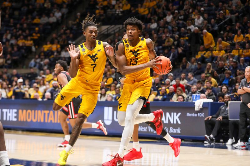 Jan 29, 2025; Morgantown, West Virginia, USA; West Virginia Mountaineers forward Amani Hansberry (13) steals a pass during the second half against the Houston Cougars at WVU Coliseum. Mandatory Credit: Ben Queen-Imagn Images
