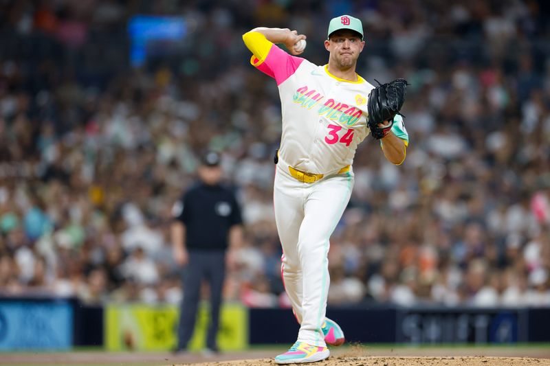 Sep 6, 2024; San Diego, California, USA;  San Diego Padres starting pitcher Michael King (34) attempts to pick off a runner at first base during the third inning against the San Francisco Giants at Petco Park. Mandatory Credit: David Frerker-Imagn Images