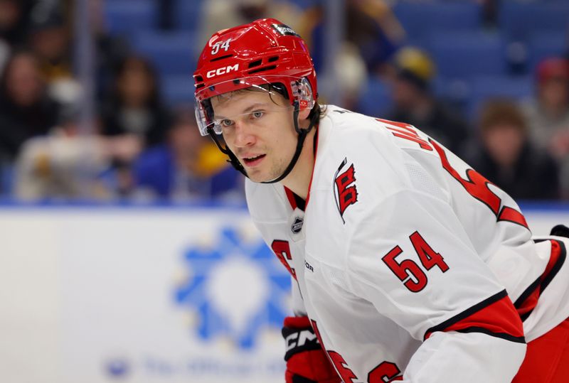 Jan 15, 2025; Buffalo, New York, USA;  Carolina Hurricanes left wing Juha Jaaska (54) looks for the puck during the first period against the Buffalo Sabres at KeyBank Center. Mandatory Credit: Timothy T. Ludwig-Imagn Images