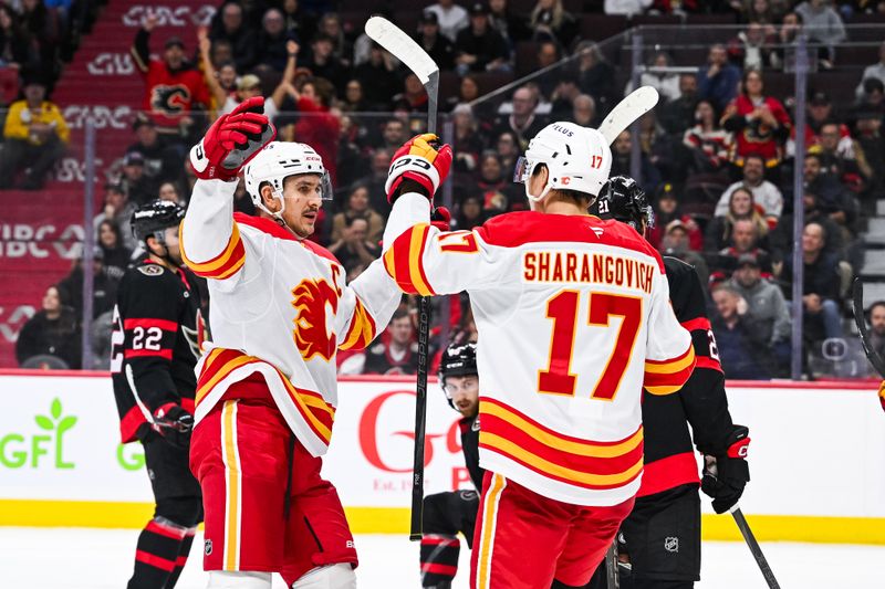 Nov 25, 2024; Ottawa, Ontario, CAN; Calgary Flames center Yegor Sharangovich (17) celebrates his goal against the Ottawa Senators with his teammates during the second period at Canadian Tire Centre. Mandatory Credit: David Kirouac-Imagn Images