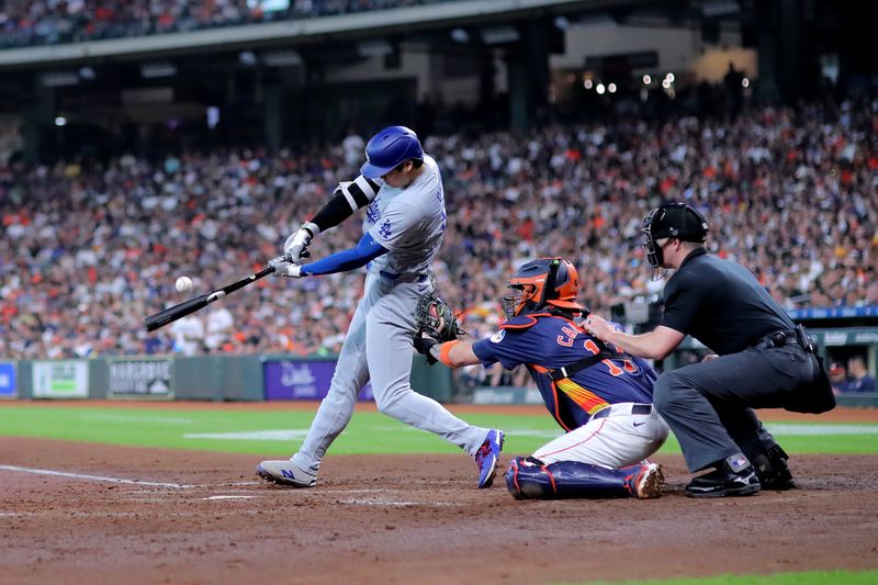 Jul 28, 2024; Houston, Texas, USA; Los Angeles Dodgers designated hitter Shohei Ohtani (17) hits a fly ball for an out against the Houston Astros during the fifth inning at Minute Maid Park. Mandatory Credit: Erik Williams-USA TODAY Sports