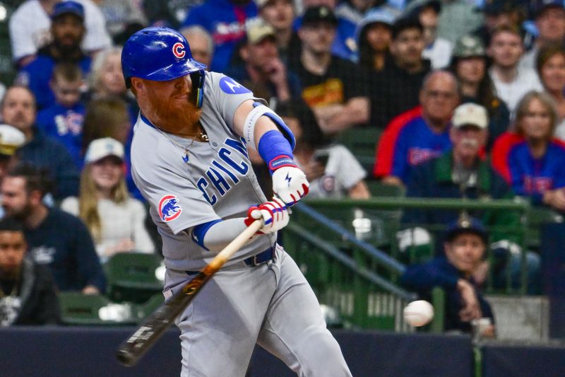 May 3, 2025; Milwaukee, Wisconsin, USA; Chicago Cubs first baseman Justin Turner (3) drives in a run with a base hit in the first inning against the Milwaukee Brewers at American Family Field. Mandatory Credit: Benny Sieu-Imagn Images