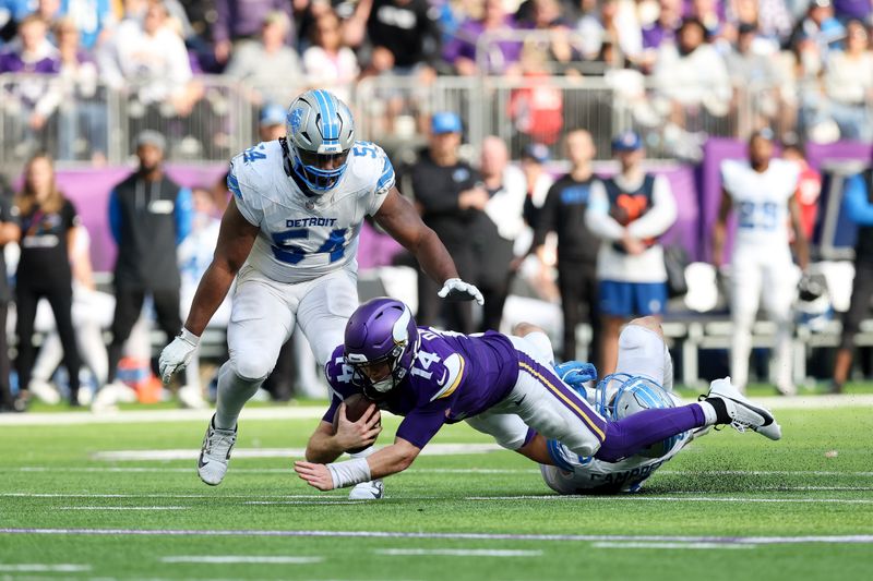 Minnesota Vikings quarterback Sam Darnold (14) is stopped by Detroit Lions linebacker Jack Campbell (46) during the second half of an NFL football game Sunday, Oct. 20, 2024 in Minneapolis. Detroit won 31-29. (AP Photo/Stacy Bengs)