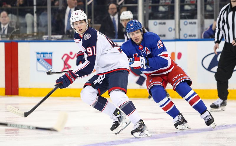 Jan 18, 2025; New York, New York, USA; Columbus Blue Jackets center Kent Johnson (91) skates ahead of New York Rangers left wing Artemi Panarin (10) during the first period at Madison Square Garden. Mandatory Credit: Danny Wild-Imagn Images