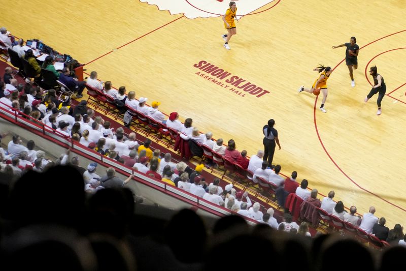 Feb 22, 2024; Bloomington, Indiana, USA;  Iowa Hawkeyes guard Caitlin Clark (22) dribbles the ball against members of the Indiana Hoosiers in the first half at Simon Skjodt Assembly Hall. Mandatory Credit: Aaron Doster-USA TODAY Sports