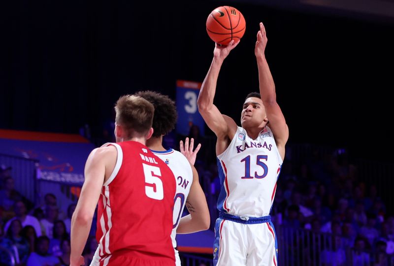 Nov 24, 2022; Paradise Island, BAHAMAS; Kansas Jayhawks guard Kevin McCullar Jr. (15) shoots over Wisconsin Badgers forward Tyler Wahl (5) during the first half at Imperial Arena. Mandatory Credit: Kevin Jairaj-USA TODAY Sports