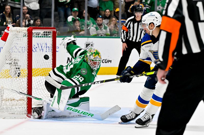 Apr 17, 2024; Dallas, Texas, USA; St. Louis Blues center Jordan Kyrou (25) looks on as his shot hits the crossbar behind Dallas Stars goaltender Jake Oettinger (29) during the overtime shootout at the American Airlines Center. Mandatory Credit: Jerome Miron-USA TODAY Sports