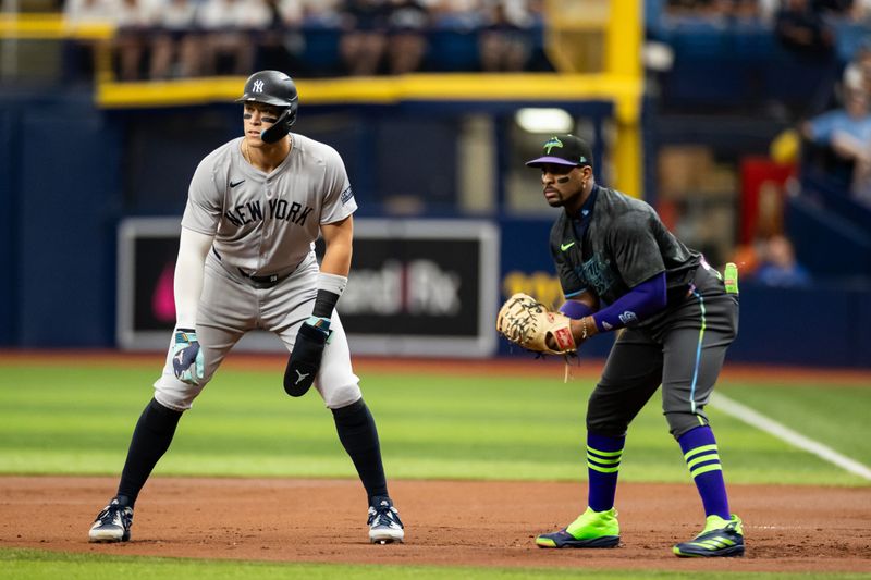 May 11, 2024; St. Petersburg, Florida, USA; New York Yankees outfielder Aaron Judge (99) leads off next to Tampa Bay Rays first base Yandy Díaz (2) during the first inning at Tropicana Field. Mandatory Credit: Matt Pendleton-USA TODAY Sports