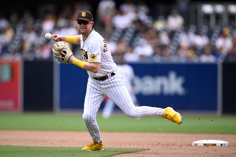 Aug 19, 2023; San Diego, California, USA; San Diego Padres second baseman Jake Cronenworth (9) cannot handle the ball on a single hit by Arizona Diamondbacks center fielder Alek Thomas (not pictured) during the sixth inning at Petco Park. Mandatory Credit: Orlando Ramirez-USA TODAY Sports