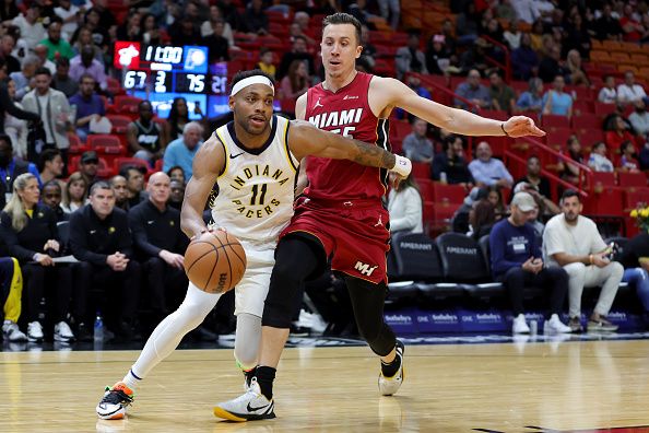 MIAMI, FLORIDA - NOVEMBER 30: Bruce Brown #11 of the Indiana Pacers drives against Duncan Robinson #55 of the Miami Heat during the third quarter of the game at Kaseya Center on November 30, 2023 in Miami, Florida. NOTE TO USER: User expressly acknowledges and agrees that, by downloading and or using this photograph, User is consenting to the terms and conditions of the Getty Images License Agreement. (Photo by Megan Briggs/Getty Images)