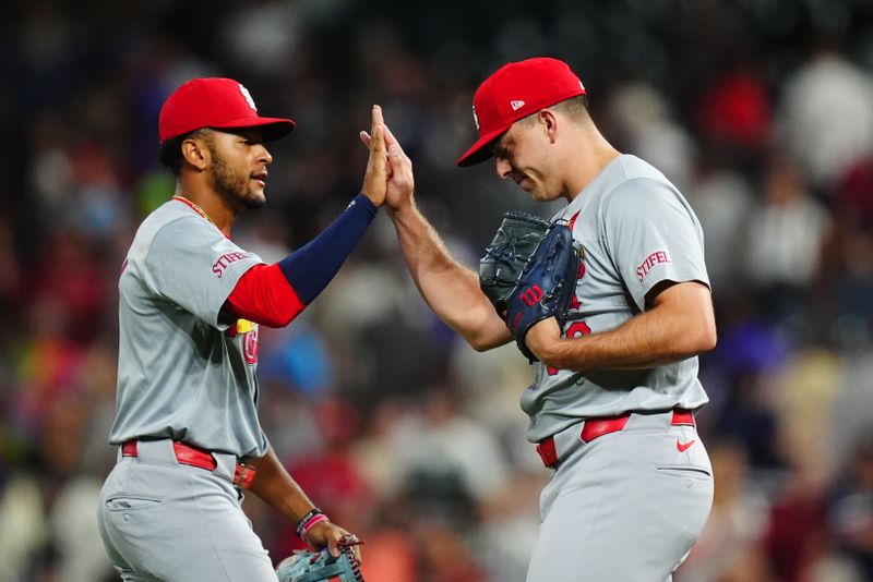 Sep 25, 2024; Denver, Colorado, USA; St. Louis Cardinals second base Jose Fermin (15) and relief pitcher Ryan Helsley (56) celebrate defeating the Colorado Rockies at Coors Field. Mandatory Credit: Ron Chenoy-Imagn Images